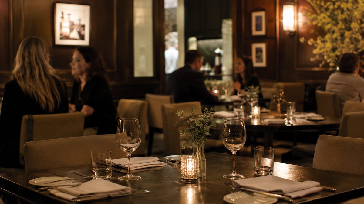Quiet restaurant dining room prepared for an evening service.