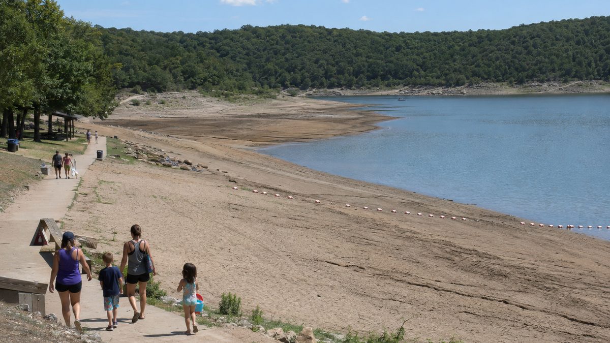 A low-water reservoir swim beach sits quiet during summer.