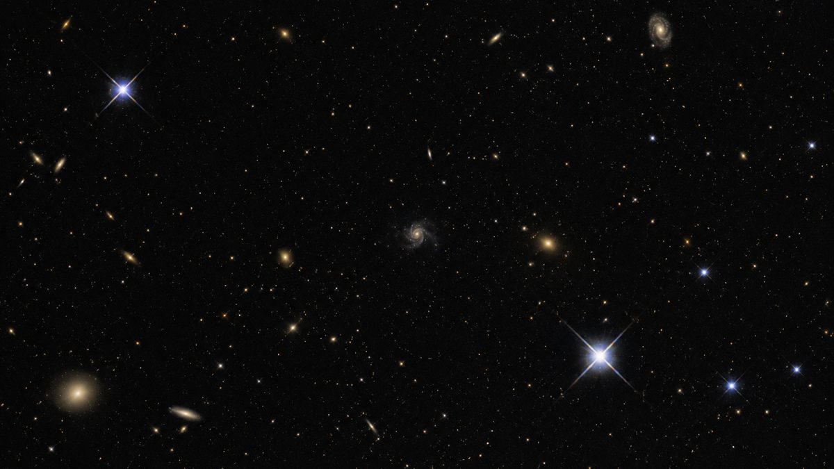 Scientists reviewing images of distant galaxies in a mission operations center.