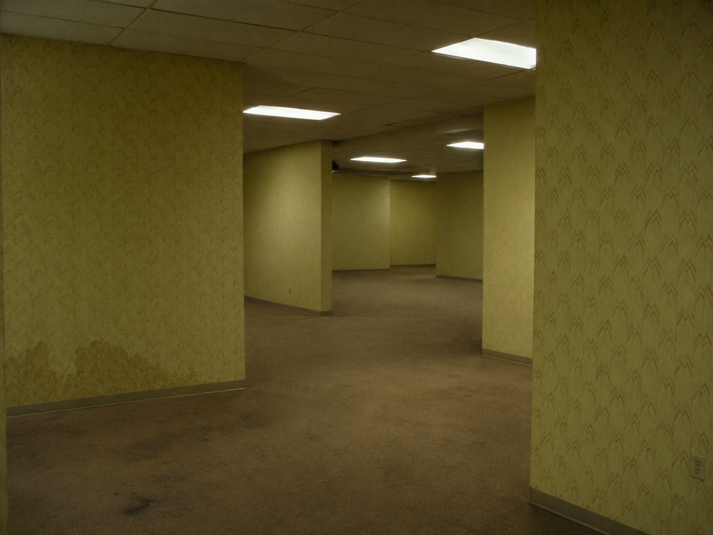 An empty movie theater with a faint glow from the screen.