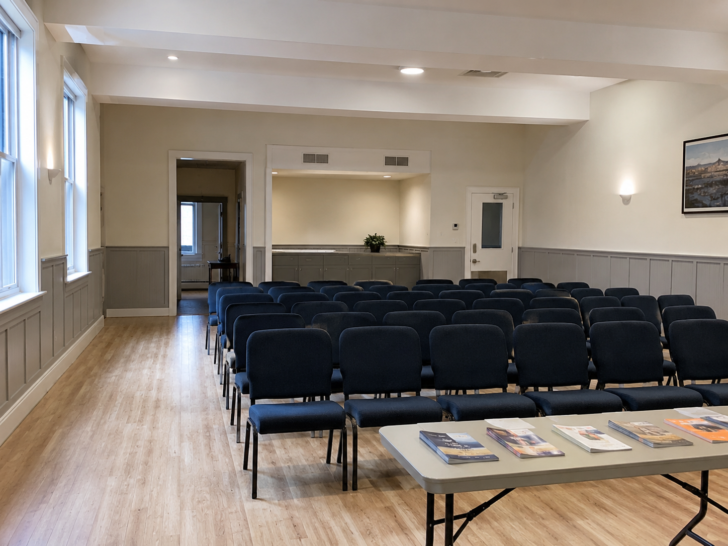 An empty community hall arranged for a public discussion.