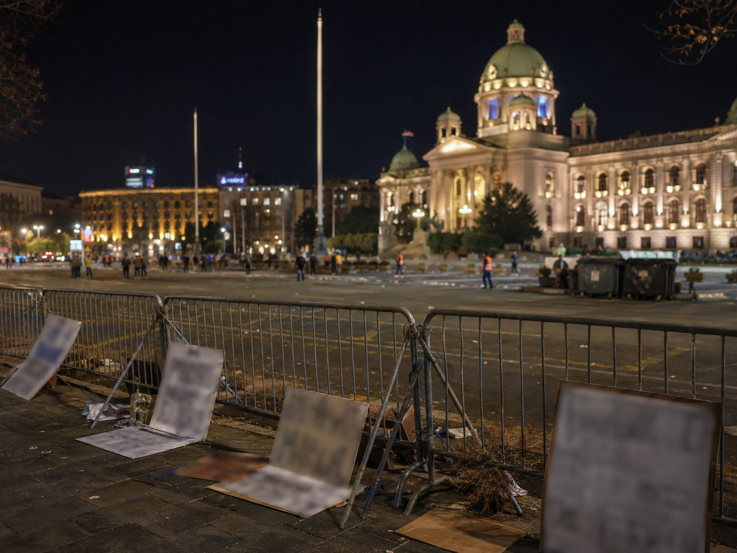 A civic square in Belgrade is seen after a protest with barriers nearby.