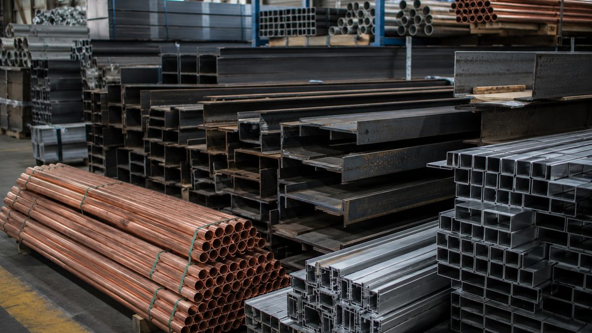 Steel beams, copper piping, and aluminum parts in a construction supply setting.