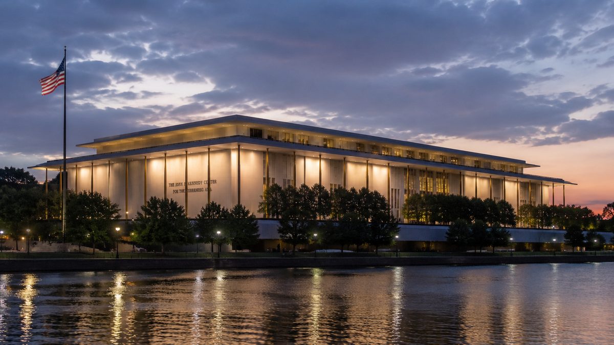 Exterior of a public performing arts building at dusk.