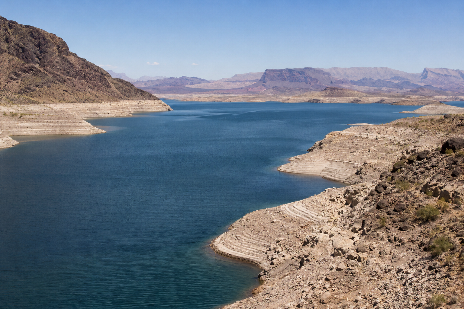 Low water levels expose pale shoreline rings along a Western reservoir.