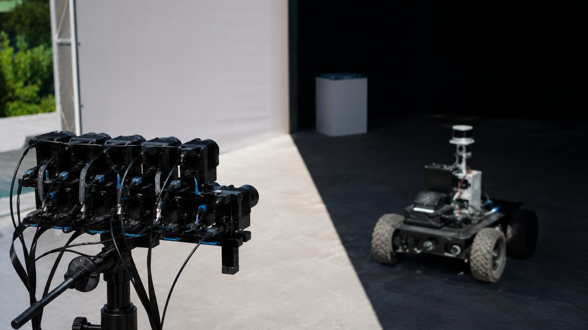 A lab camera sensor faces a test scene split between bright light and shadow.